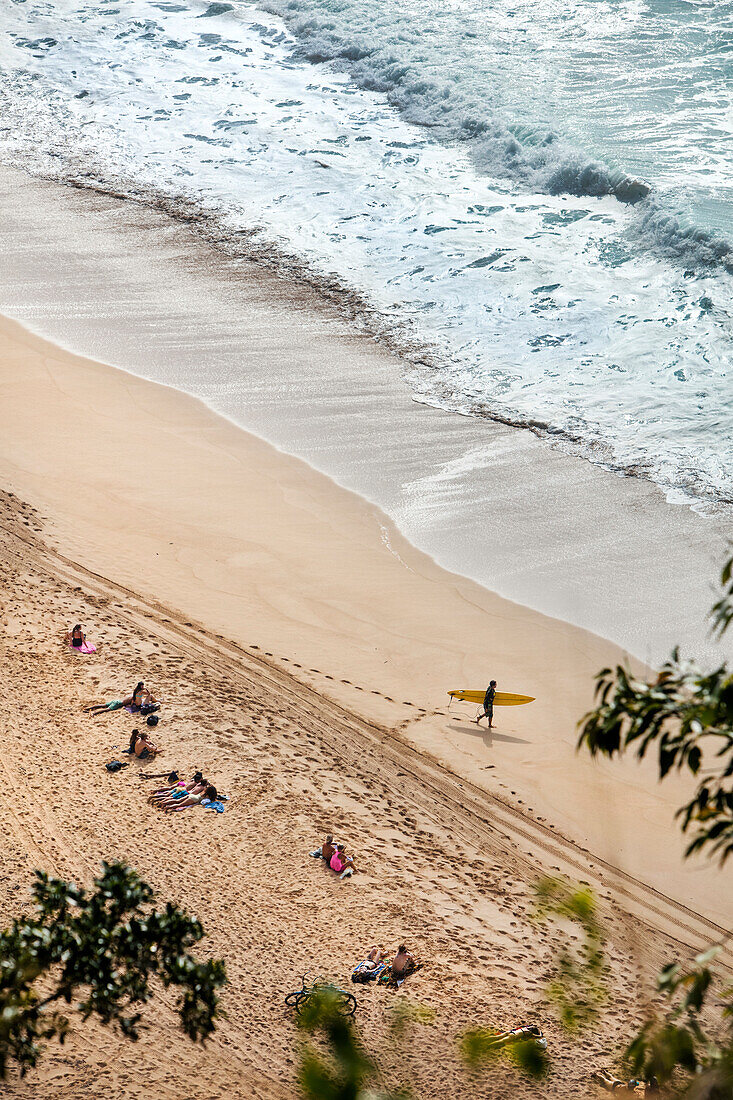 HAWAII, Oahu, North Shore, individuals spending time on the beach at Waimea Bay