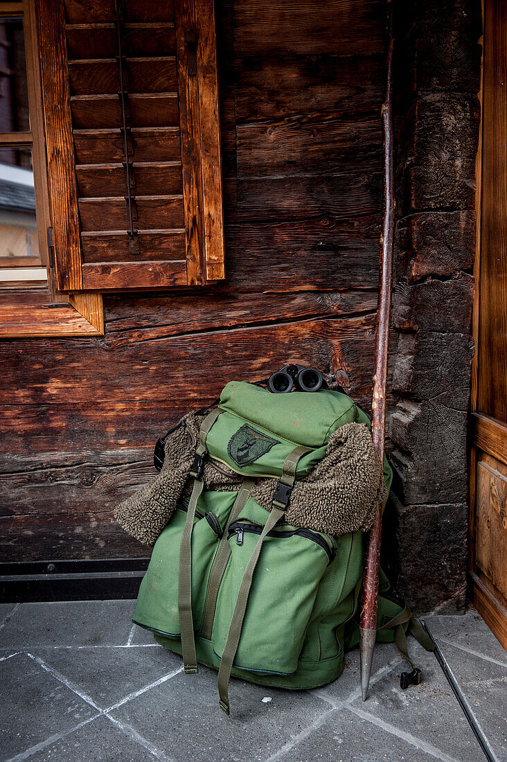 backpack, wooden wall, hunter, ranger, winterly landscape, the Alps, South Tyrol, Trentino, Alto Adige, Italy, Europe