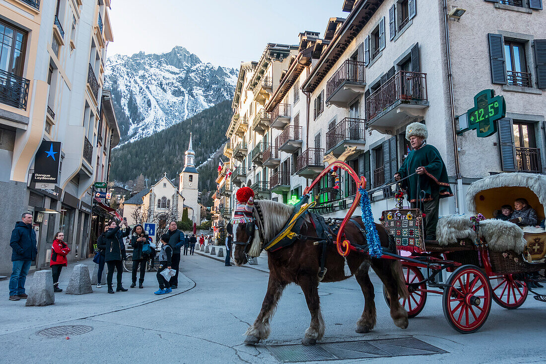 Tourists Ride In A Buggy Pulled By A Horse Through The Streets; Chamonix, France