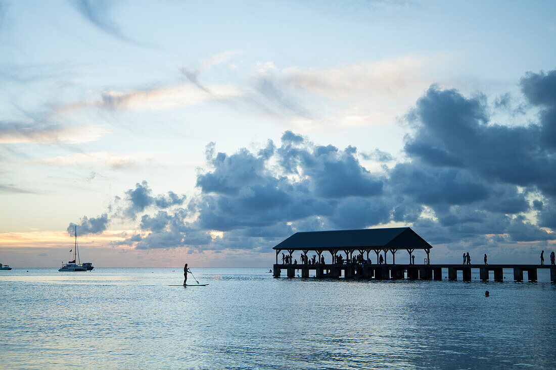 Tourists on Hanalei pier at sunset; Hanalei, Kauai, Hawaii, United States of America; Hanalei, Kauai, Hawaii, United States of America