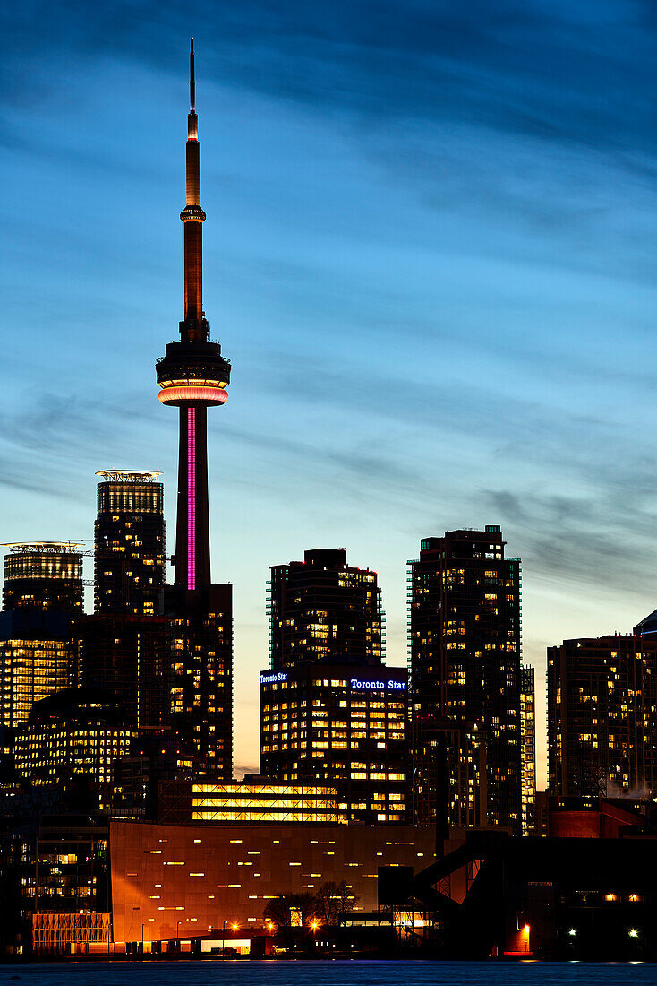 Skyline Of Toronto And Cn Tower Illuminated At Sunset; Toronto, Ontario, Canada