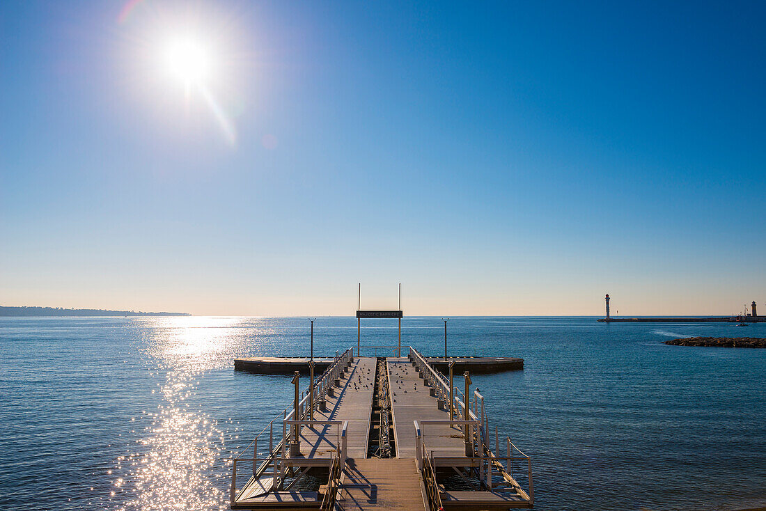 Docks Leading Out To The Blue Water Of The Mediterranean Sea Along The French Rivera; Cannes, Cote D'azur, France