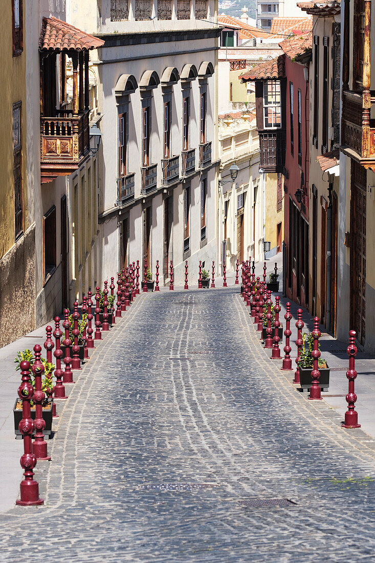 Street Lined With Residential Buildings And Decorative Red Posts In The Historic Part Of Town; La Oratava, Tenerife North, Canary Islands, Spain