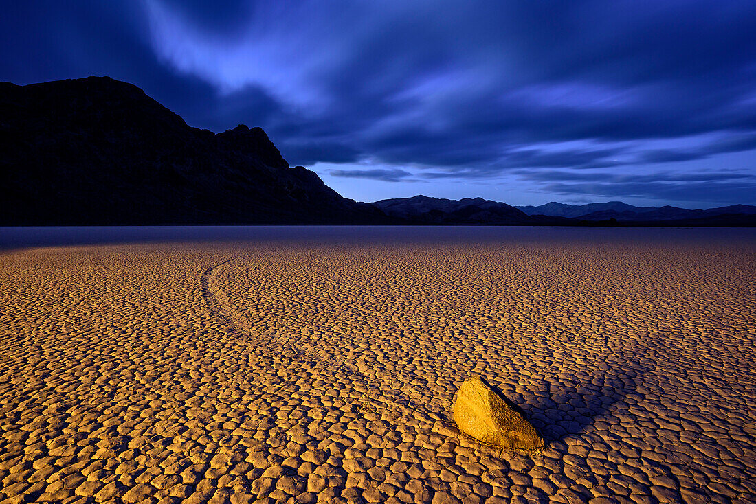 Sailing stone with race track in clay pan, Racetrack Playa, Death Valley National Park, California, USA