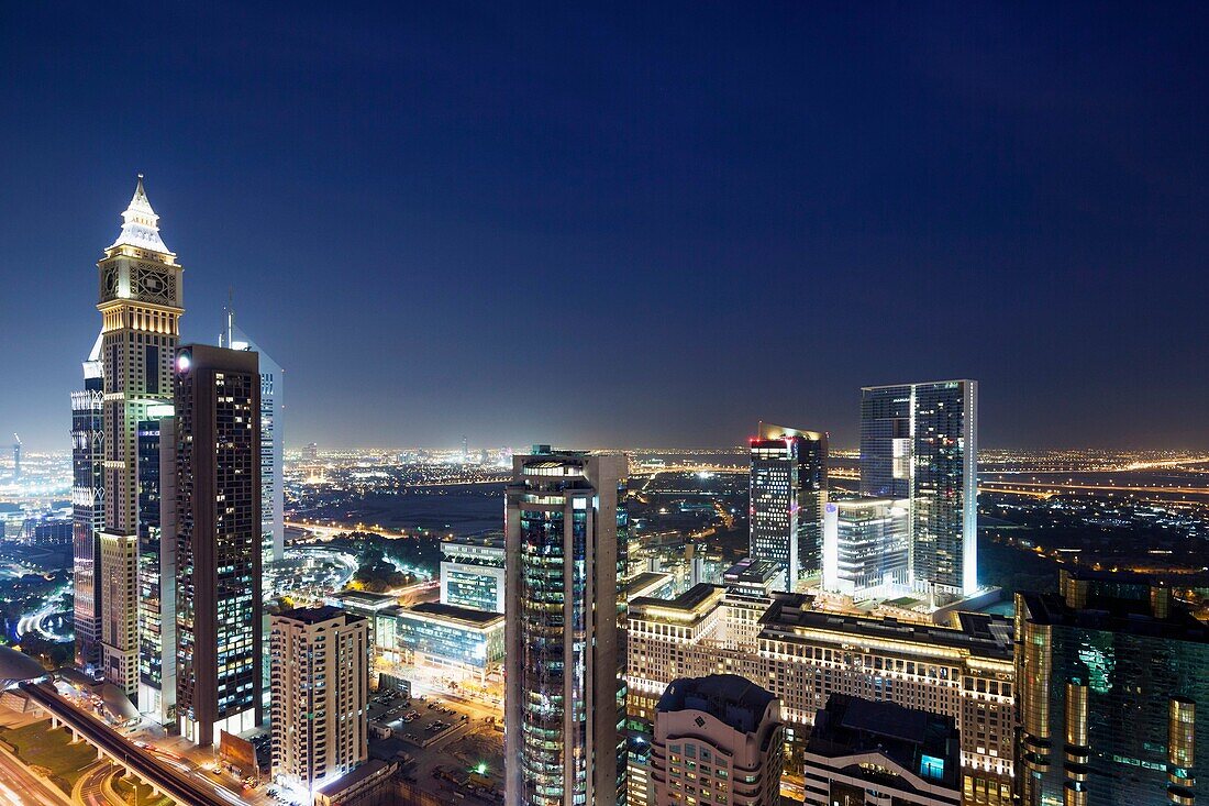 UAE, Dubai, Downtown Dubai, high rise buildings along Sheikh Zayed Road, elevated view, dusk.