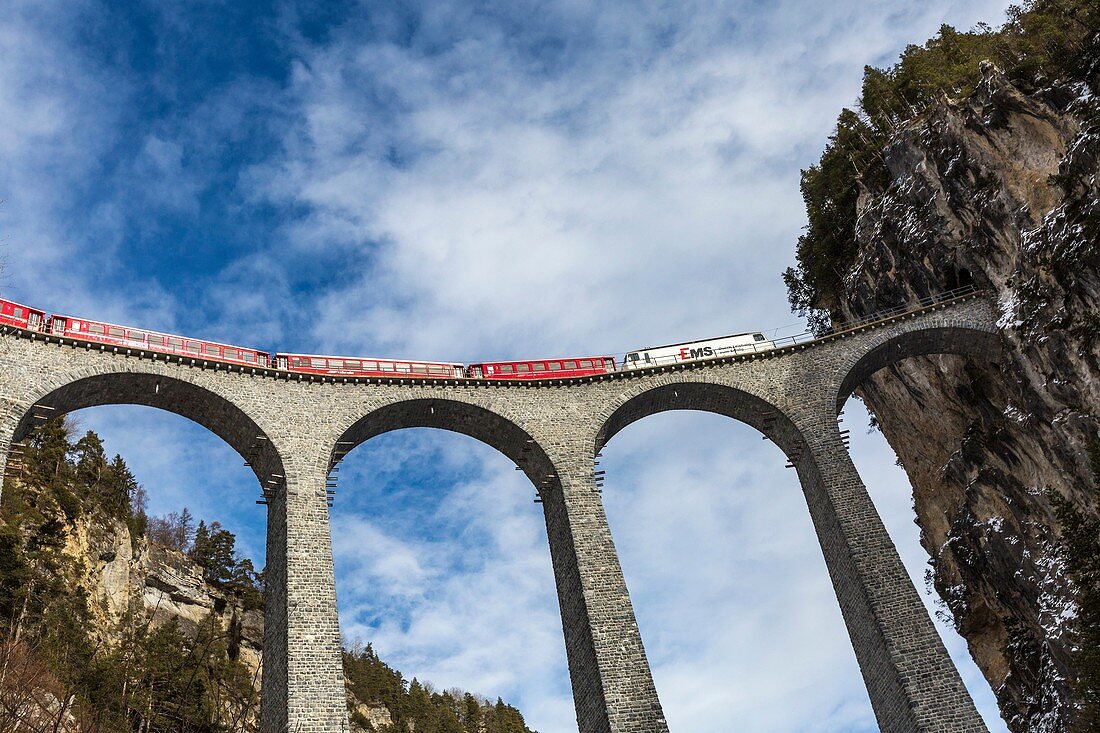 Bernina Express red train along Landwasser Viaduct. Filisur, Graubunden, Switzerland, Europe.