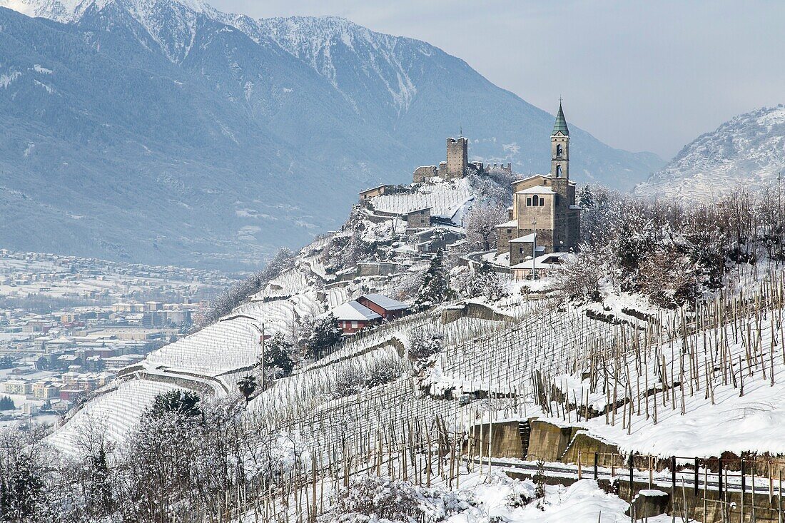 Church of San Atonio Abate and Castel Grumello in winter. Montagna, Valtellina, Lombardy, Italy Europe.