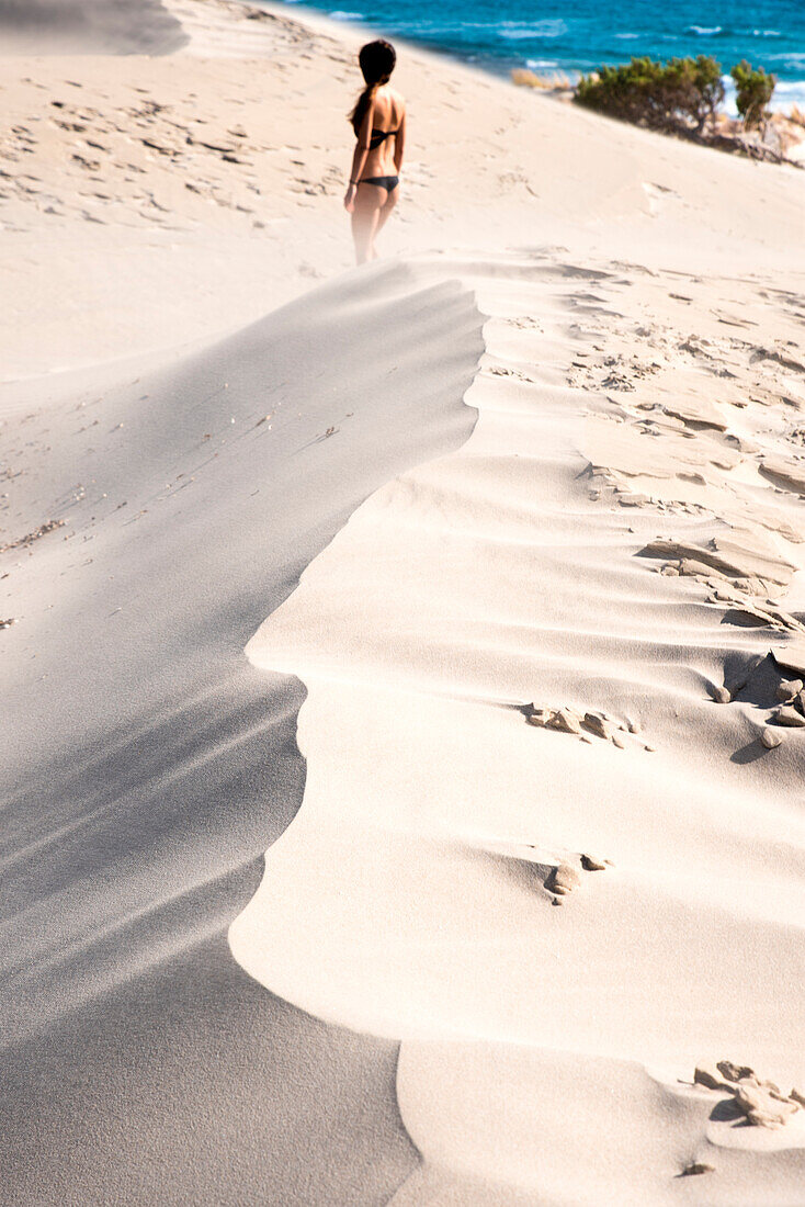 Woman standing on sand dunes, Is Arenas Biancas, Teulada, province of Cagliari, Sardinia, Italy