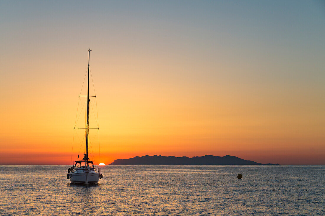 Sailing boat at sunrise, on background Capraia Island (Macinaggio, Rogliano, Bastia, Haute-Corse department, Corsica, France, Europe)