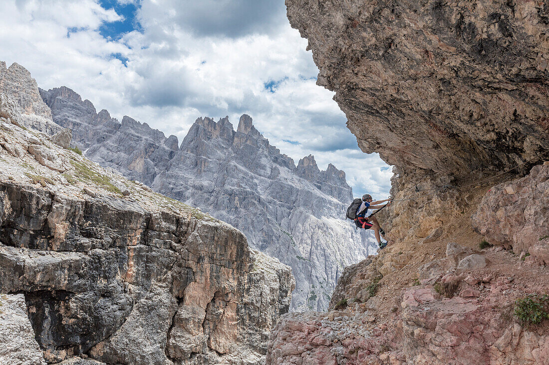 Climber on the via ferrata Cengia Gabriella, Popera group, Giralba, Sexten Dolomites, Belluno, Veneto, Italy