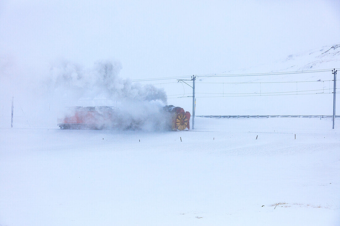 Snowplow of Bernina Express train during a snow storm, canton of Graubünden, Engadin Valley, Switzerland