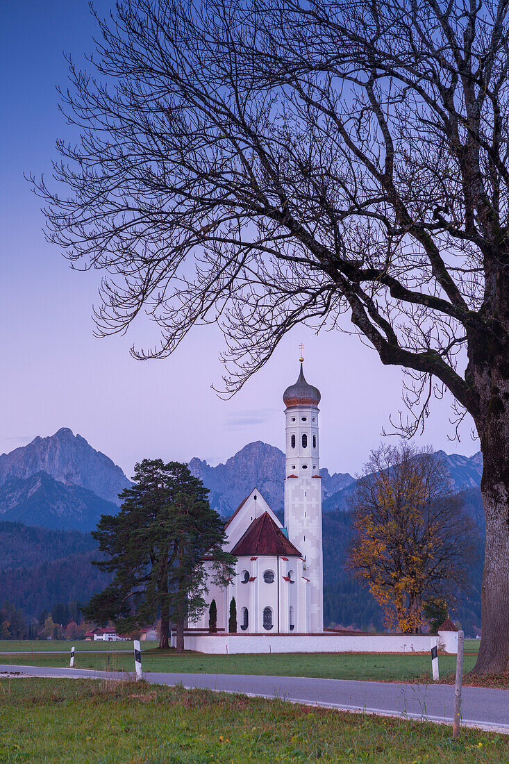 Sunrise on St Coloman Church surrounded by woods, Schwangau, Fussen, Bavaria, Southwest Bavaria, Germany, Europe