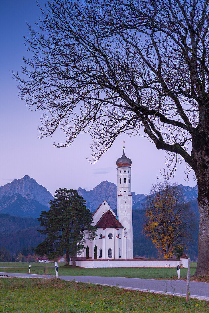 Sunrise on St Coloman Church surrounded by woods. Schwangau, Fussen, Bavaria, Southwest Bavaria, Germany, Europe.