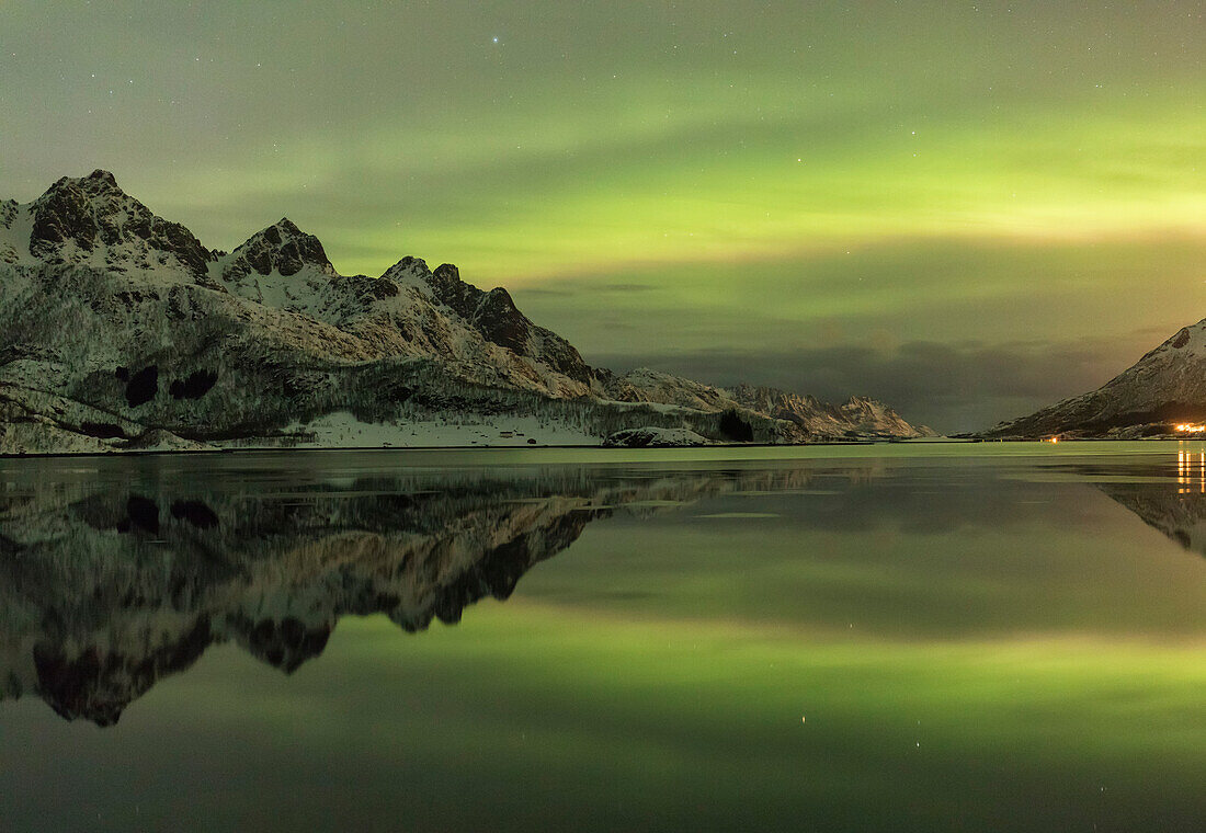 Eidsfjord Mountain Range It reflects in the water under a northern lights Holmstad, Sortland, Vesterålen, Norway,Europe