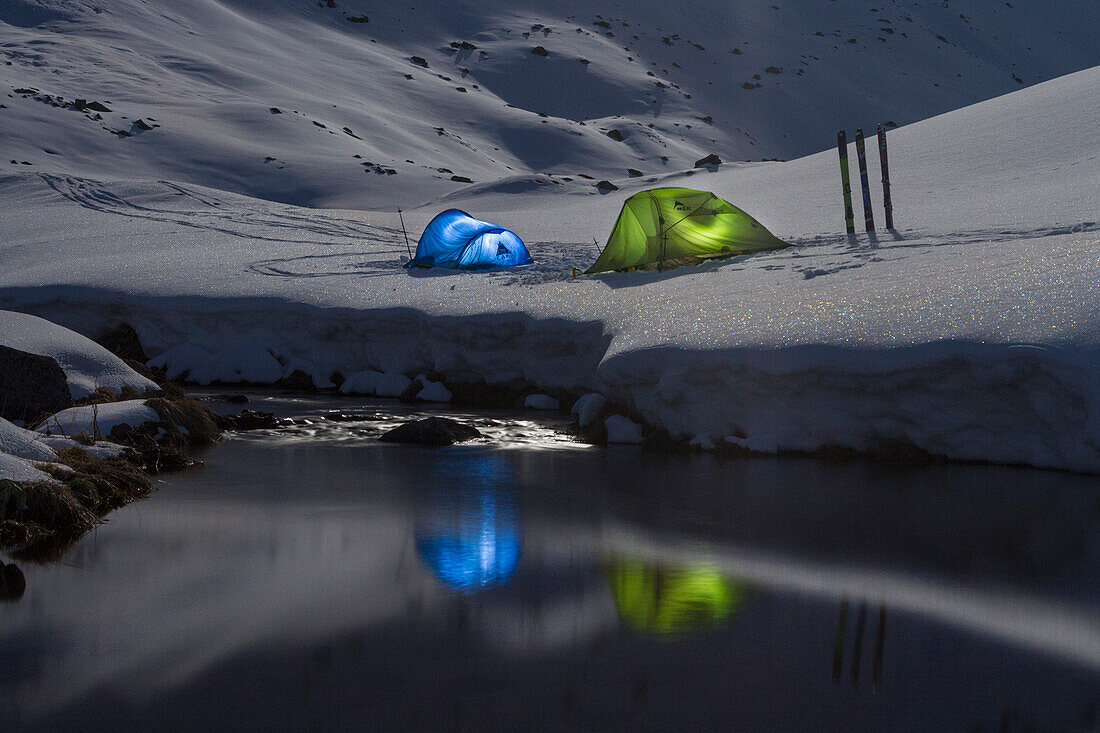 Tents light during a winter starring sky night, Fluela pass, Switzerland, Europe