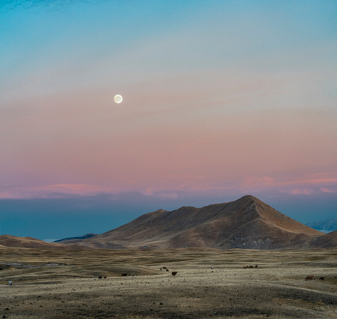 Sunset and moon on the glacial plain of Campo Imperatore, Campo Imperatore, L'Aquila province, Abruzzo, Italy, Europe