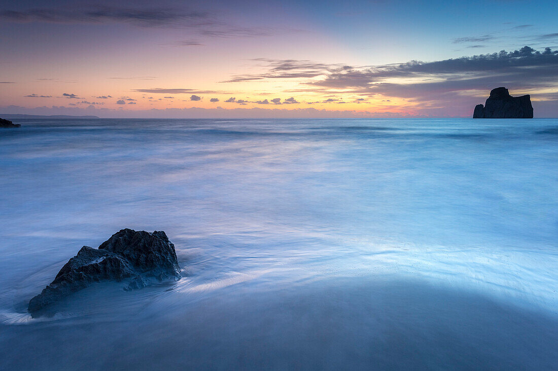 Sunset at Masua beach, in front of the Pan di Zucchero reef, Masua, Sulcis-iglesiente, Iglesias, Sardinia, Italy