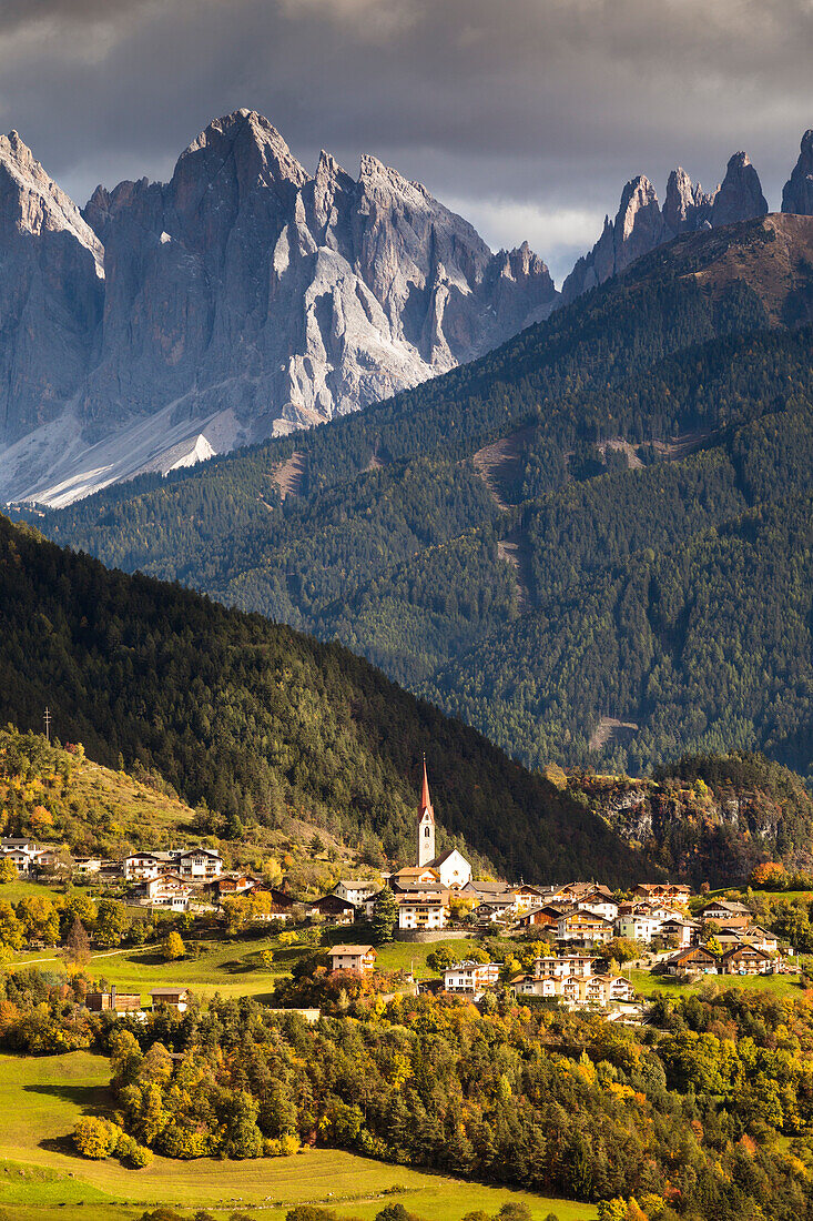 an autumnal view of Teis, a small village in Villnössertal with the Geisler Group in the background, Bolzano province, South Tyrol, Trentino Alto Adige, Italy