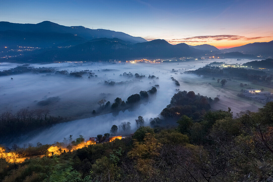 Mist over Adda river seen from Airuno at the Santuario Madonna della Rocchetta, Airuno, Parco dell'Adda Nord, Lecco province, Brianza, Lombardy, Italy