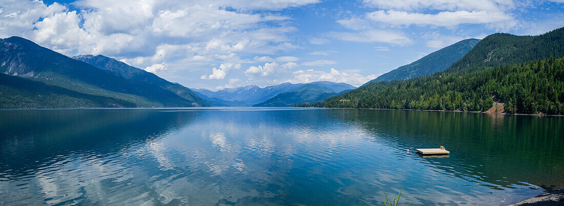 A wooden dock floating in Kootenay Lake in the Selkirk Mountains; Nelson, British Columbia, Canada