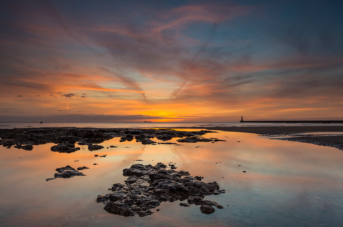 Sunrise reflections in a tide pool along the coast; Sunderland, Tyne and Wear, England