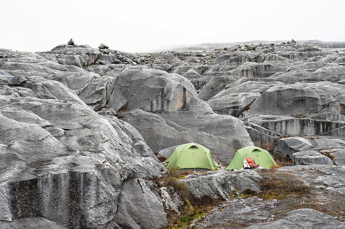 Two tents at campsite on moraine during climb to Pulpito del Diablo in Sierra Nevada del Cocuy, Colombia