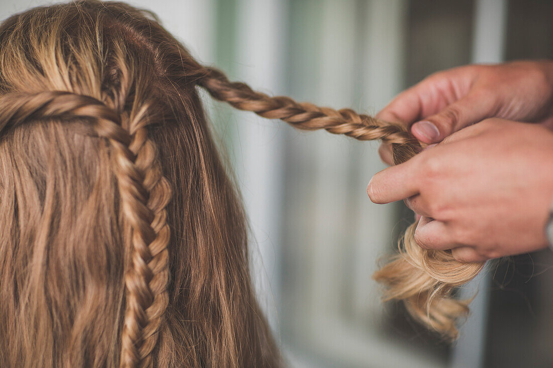 Person braiding hair of woman, Abbotsford, British Columbia, Canada
