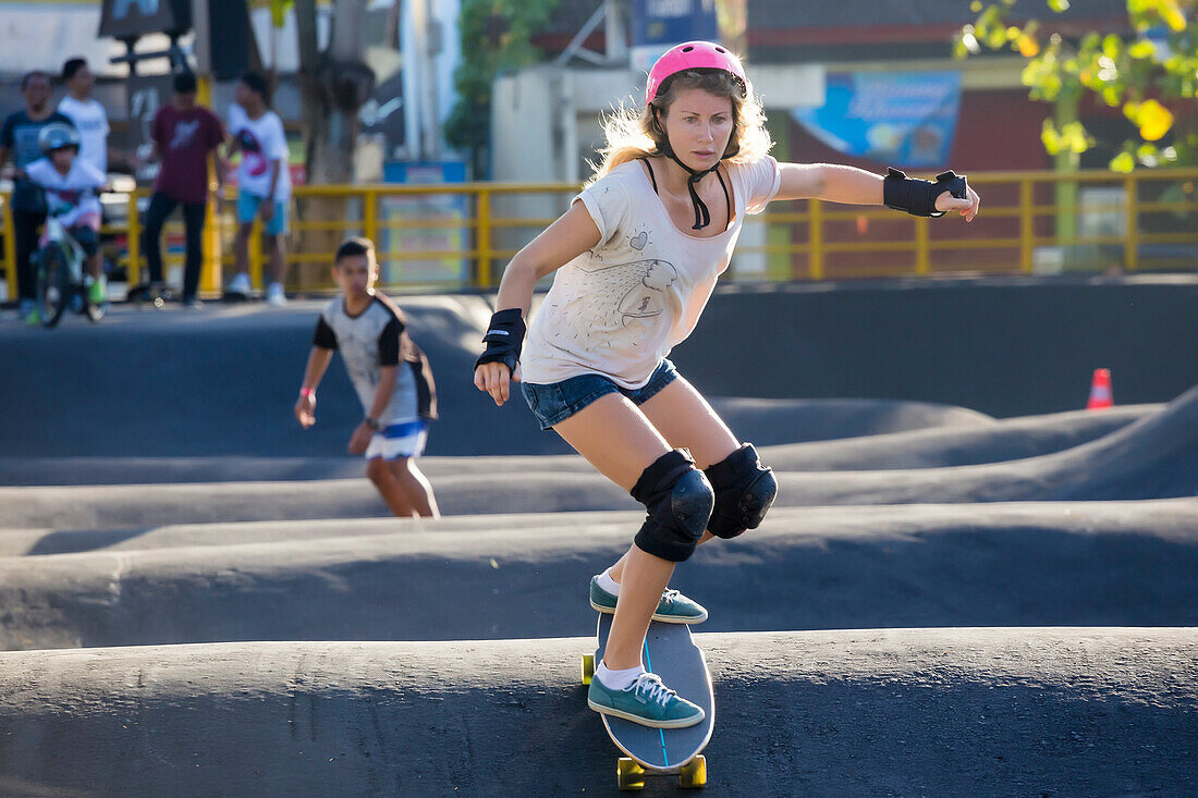 Woman skateboarding in skate park, Canggu, Bali, Indonesia