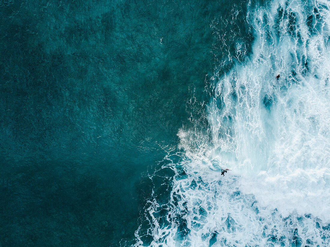 Aerial view of surfer catching wave in sea, Tenerife, Canary Islands, Spain