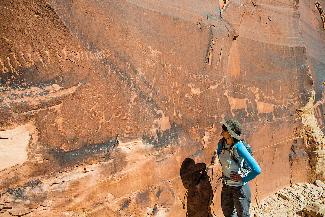 Woman standing at Procession panel, Comb Ridge, Bears Ears National Monument, Utah, USA