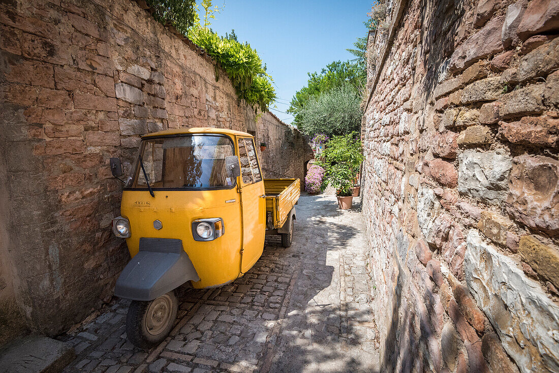 The apecar in a small street of Spello, Province of Perugia, Umbria, Italy, Europe