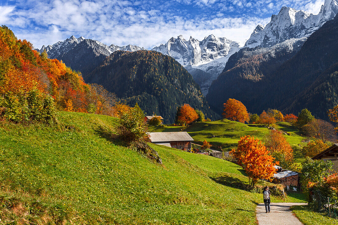 A tourist visit the village of Soglio in the Autumn, Maloja region, Canton of Graubunden, Bregaglia valley, Switzerland, Europe
