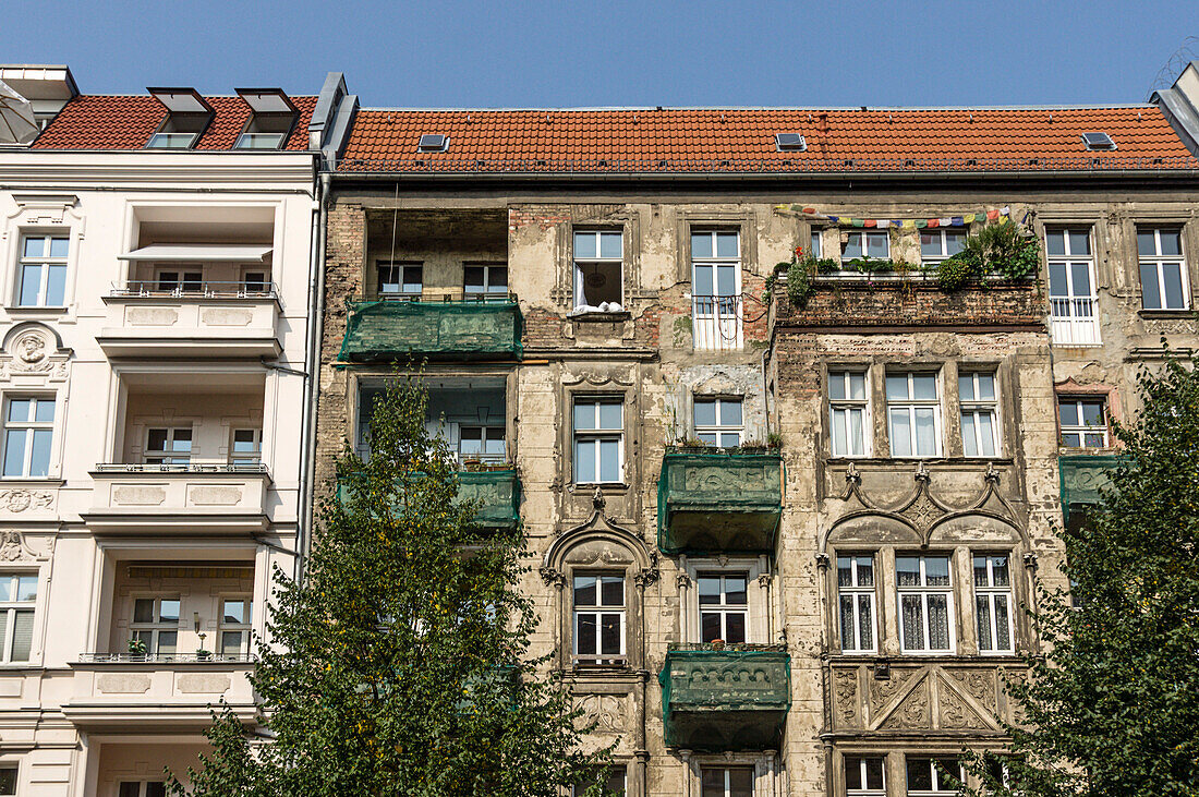 Restored House besides unrestored old building  in Prenzlauer Berg, Berlin, Germany