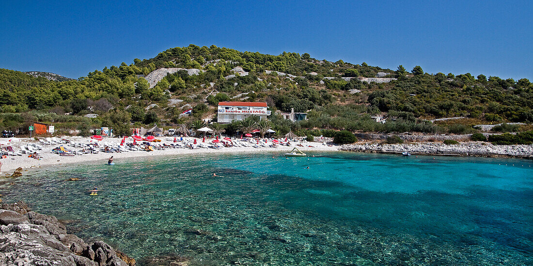 Cristal clear water at  Hvar beach  Pokonji dol with  Konoba Mustaco Restaurant , Croatia