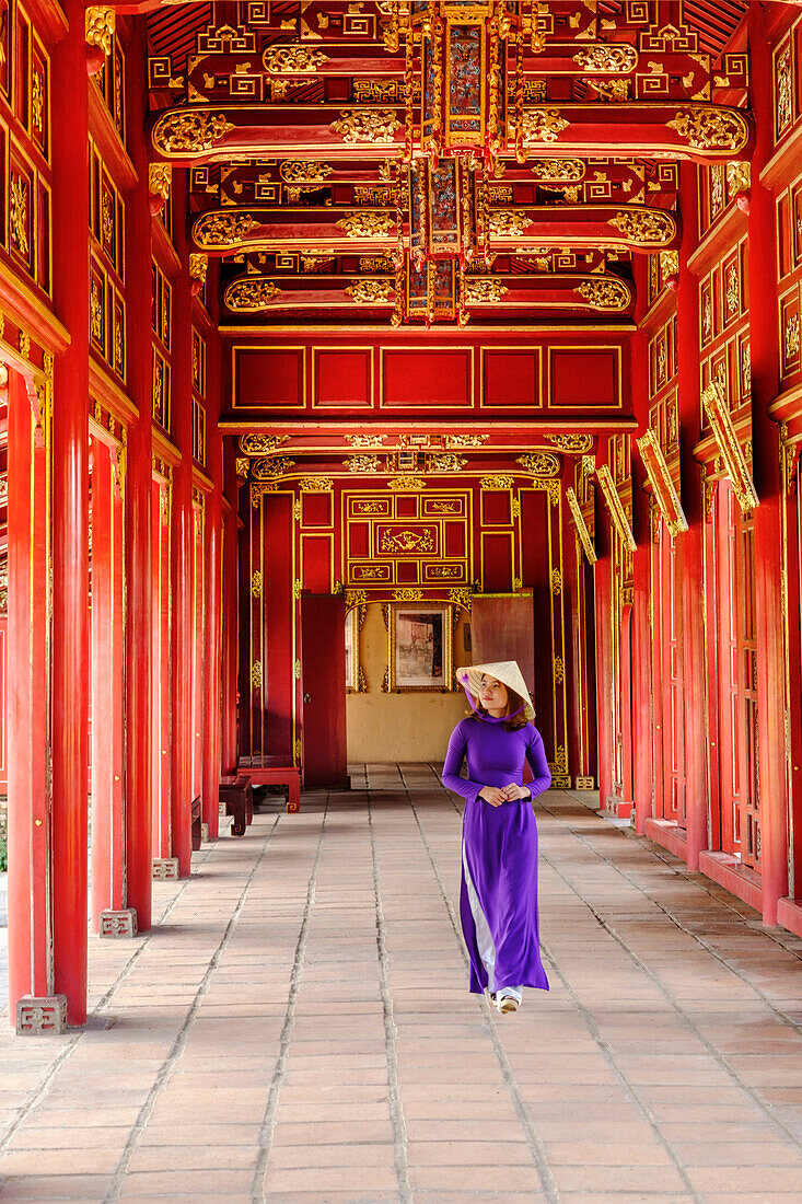 A woman in a traditional Ao Dai dress and Non La conical hat in the Forbidden Purple City of Hue, UNESCO World Heritage Site, Thua Thien Hue, Vietnam, Indochina, Southeast Asia, Asia