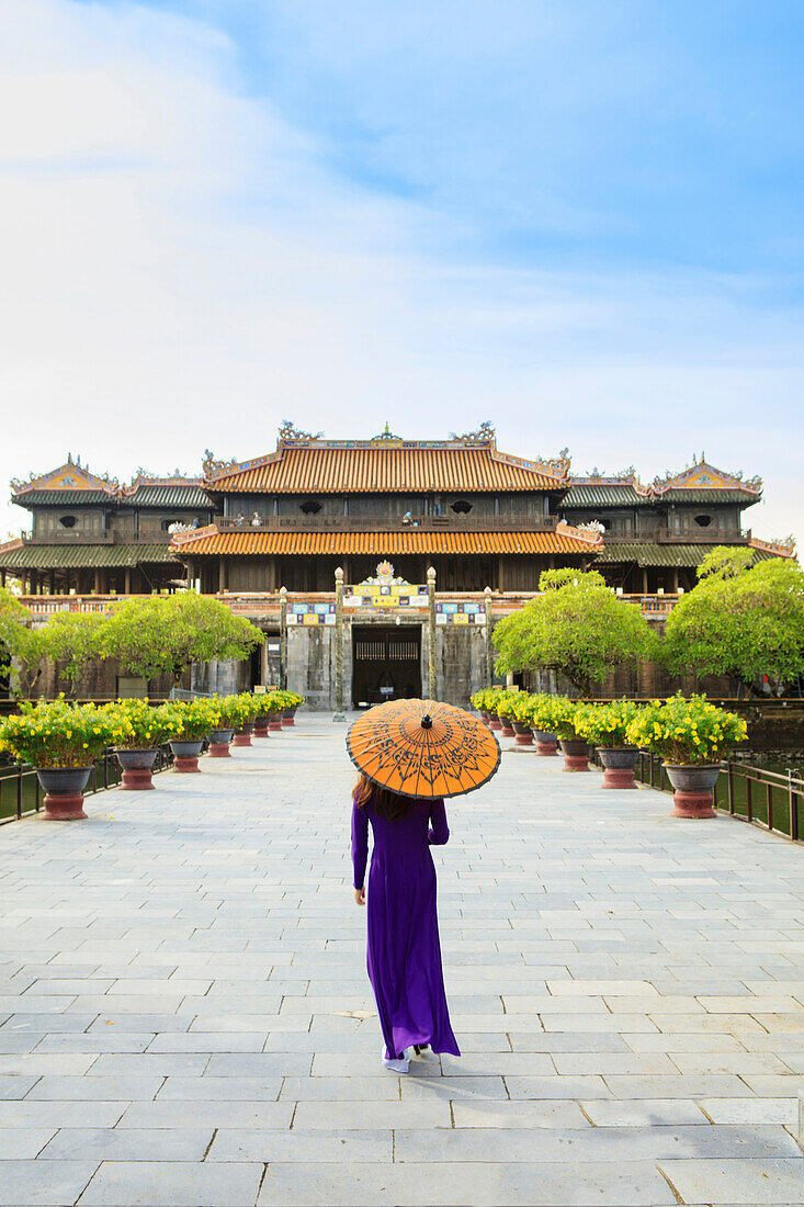 Woman in a traditional Ao Dai dress with a paper parasol in the Forbidden Purple City of Hue, UNESCO World Heritage Site, Thua Thien Hue, Vietnam, Indochina, Southeast Asia, Asia