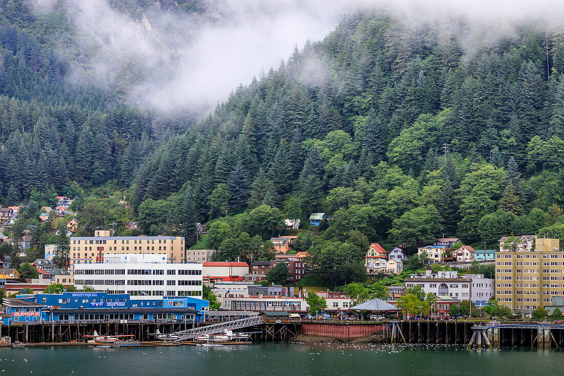 Juneau, State Capital, view from the sea, mist clears over downtown buildings, mountains, forest and float planes, Alaksa, United States of America, North America