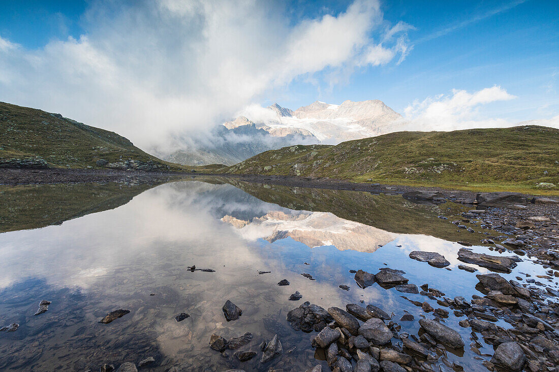 Piz Arlas, Cambrena, Caral reflected in lake, Bernina Pass, Poschiavo Valley, Engadine, Canton of Graubunden, Switzerland, Europe