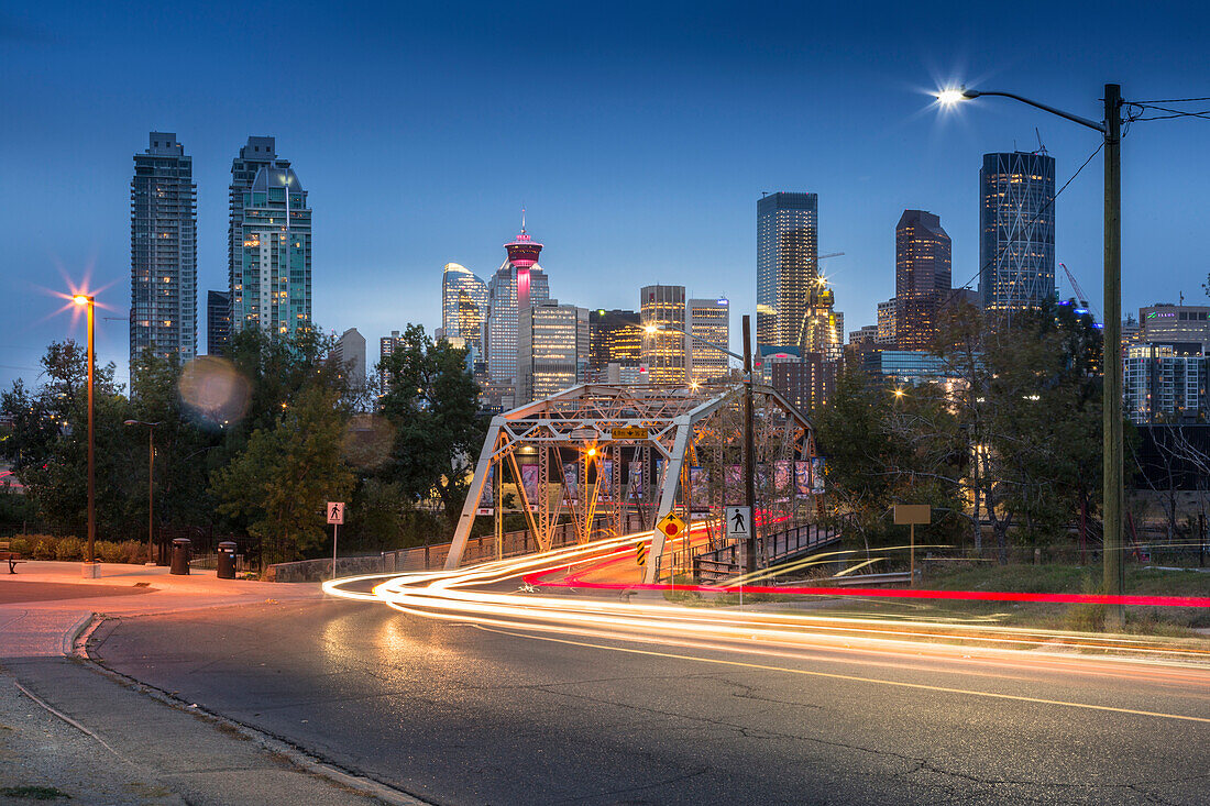 Car trail lights through Macdonal Avenue bridge and Downtown skyline at dusk, Calgary, Alberta, Canada, North America
