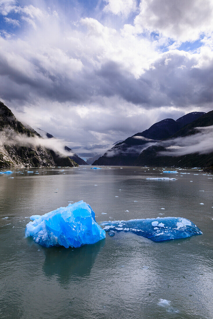 Spectacular Tracy Arm Fjord, brilliant blue icebergs and backlit clearing mist, mountains and South Sawyer Glacier, Alaska, United States of America, North America