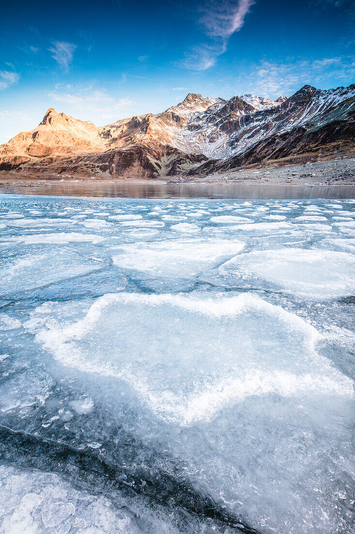 Frozen lake Montespluga at dawn, Chiavenna Valley, Sondrio province, Valtellina, Lombardy, Italy, Europe
