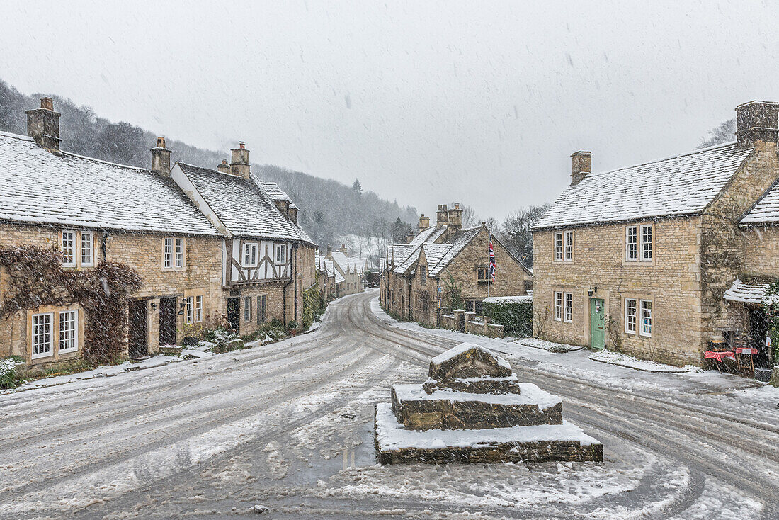 Looking down the quintessential English village of Castle Combe in the snow, Wiltshire, England, United Kingdom, Europe