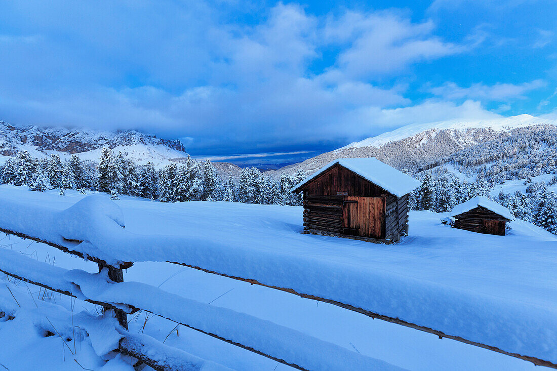 Old snow-covered huts during twilight, Erbe Pass, Funes Valley, Sudtirol (South Tyrol), Dolomites, Italy, Europe