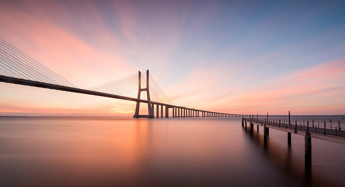 Sunrise colors in Tagus River and frame the Vasco da Gama bridge in Lisbon Portugal Europe