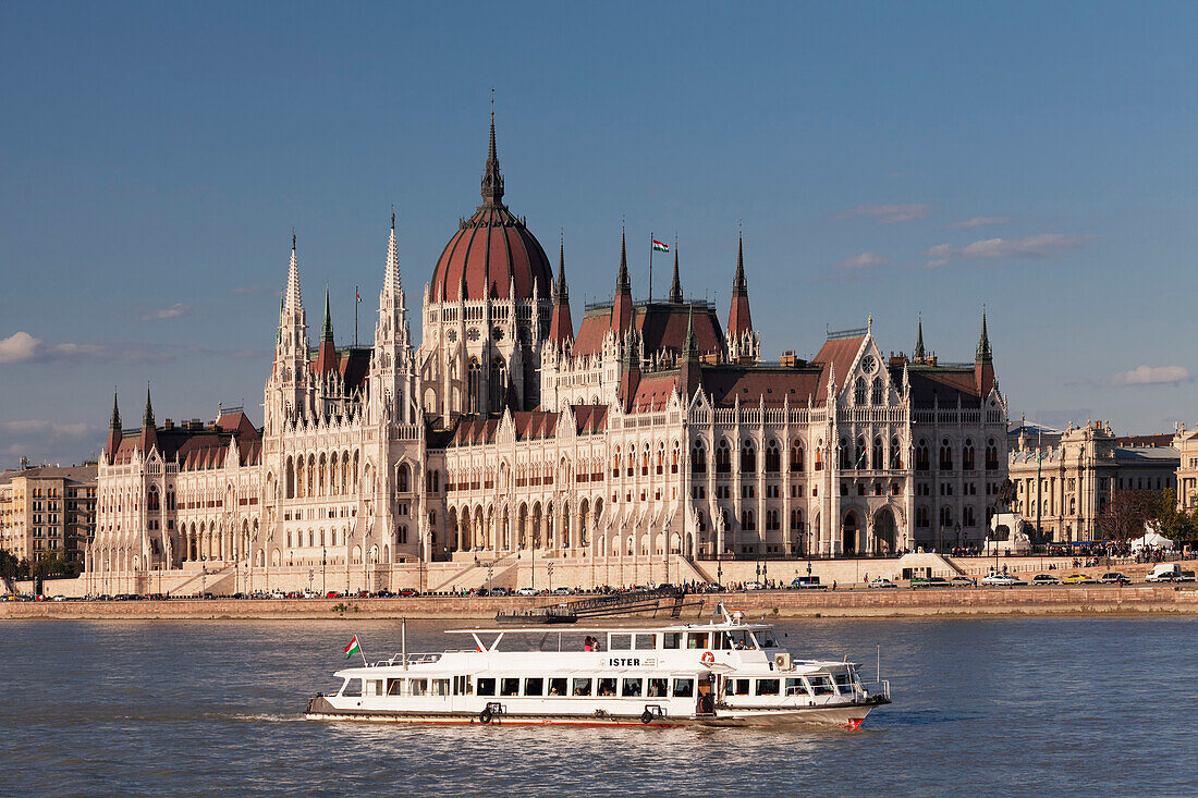 Excursion boat on the Danube River, Parliament Building at sunset, UNESCO World Heritage Site, Budapest, Hungary, Europe