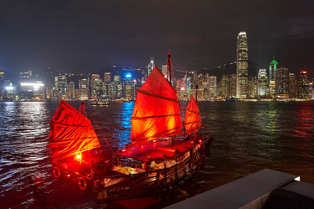 Traditional Chinese junk boat for tourists on Victoria Harbour illuminated at night, Hong Kong, China, Asia