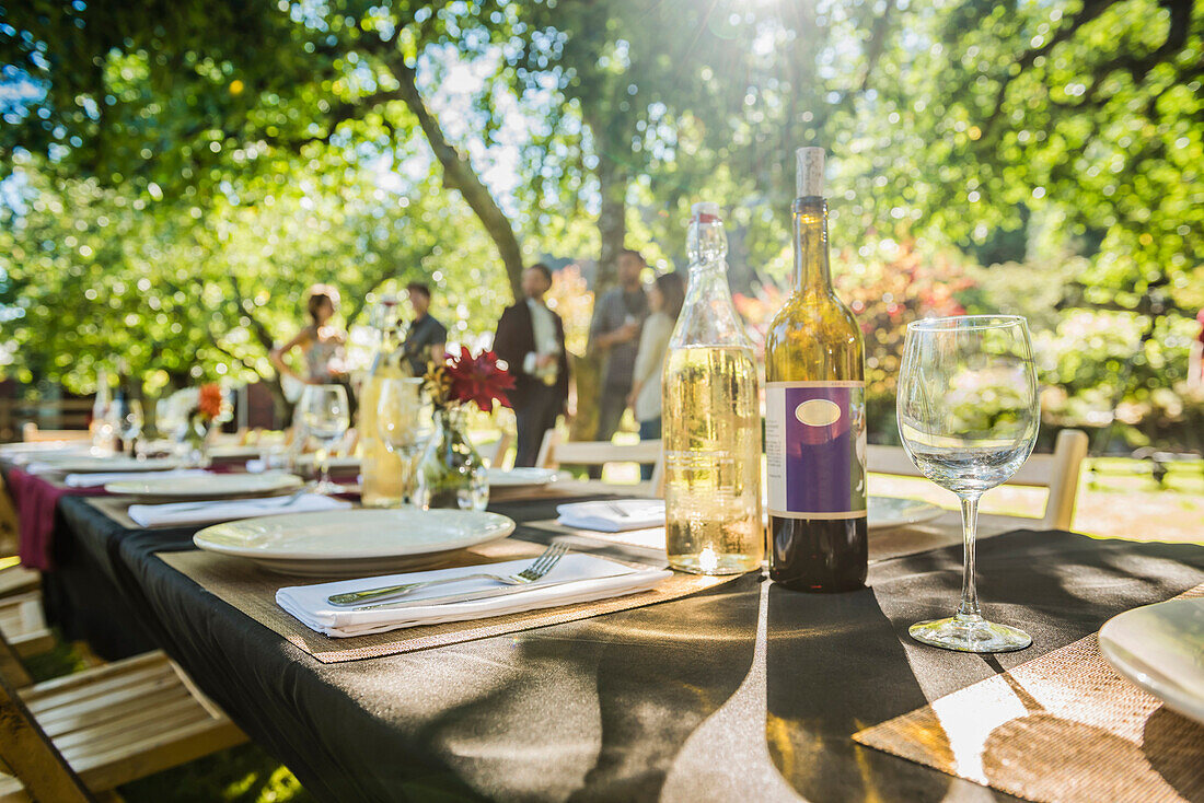 Wine bottles on table at party outdoors