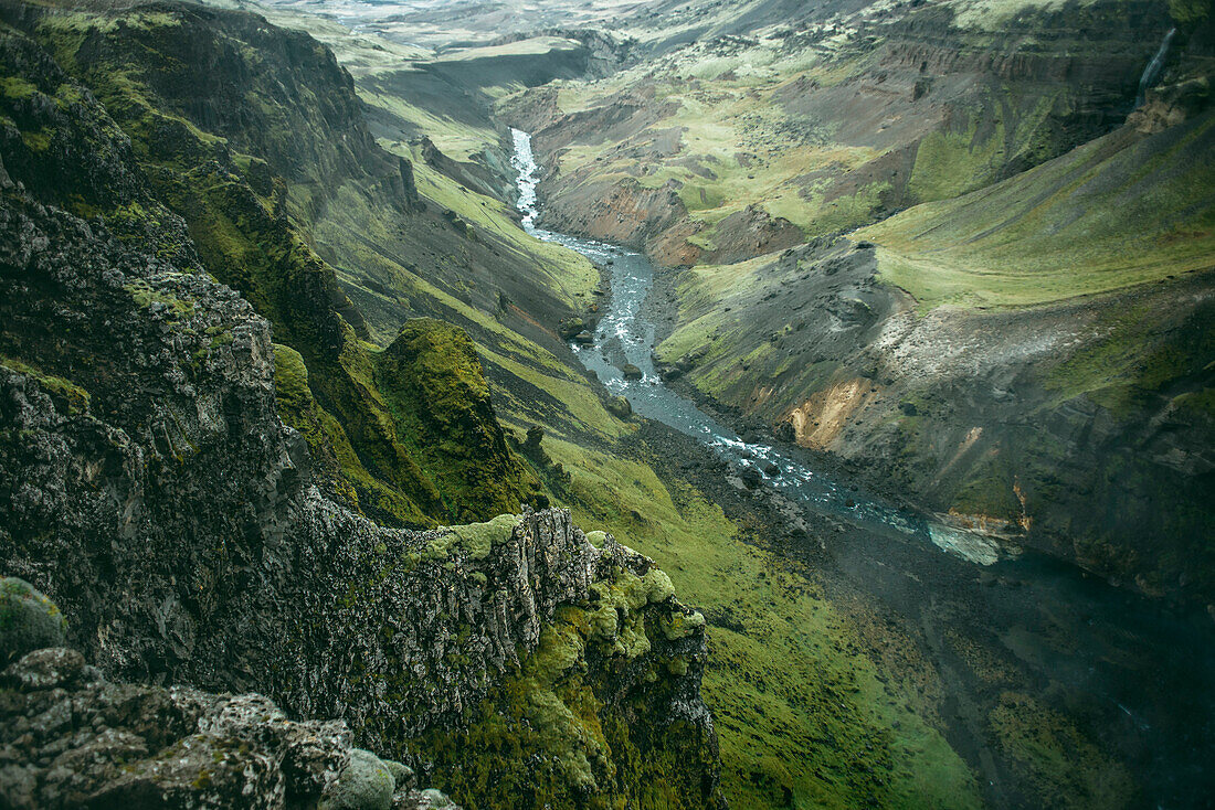 Scenic view of river in green valley