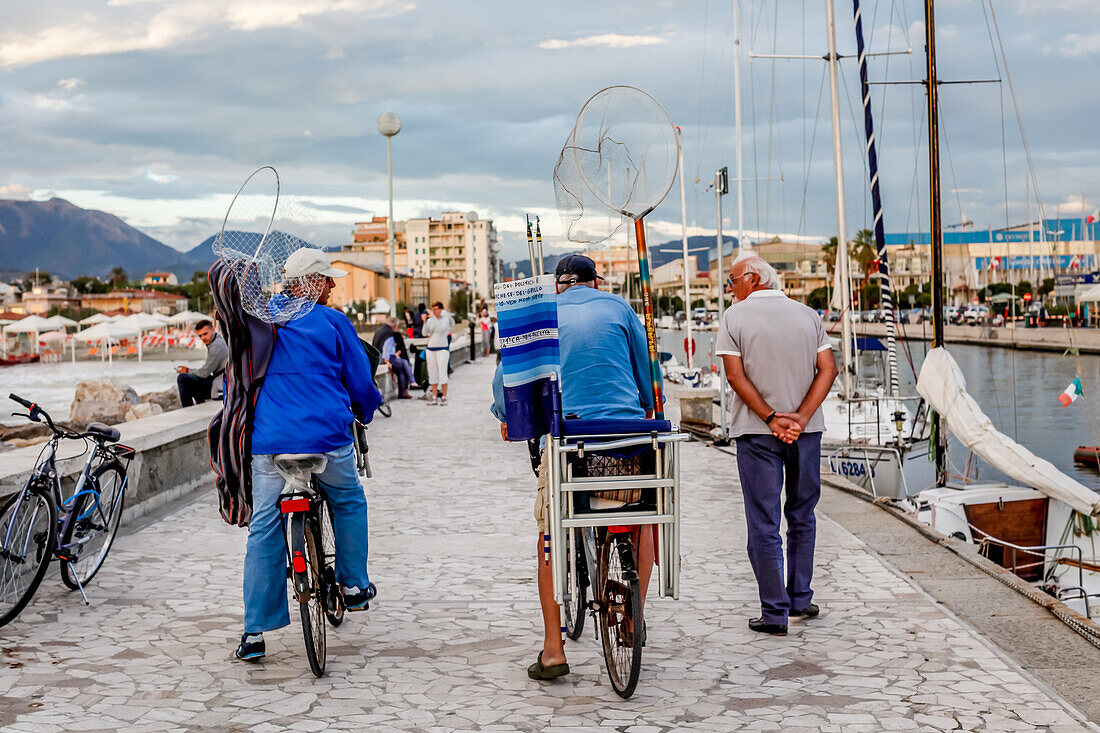 Fishermen going home on the Pier in Viareggio at the Sunset, Viareggio, Tuscany, Italy, Europe