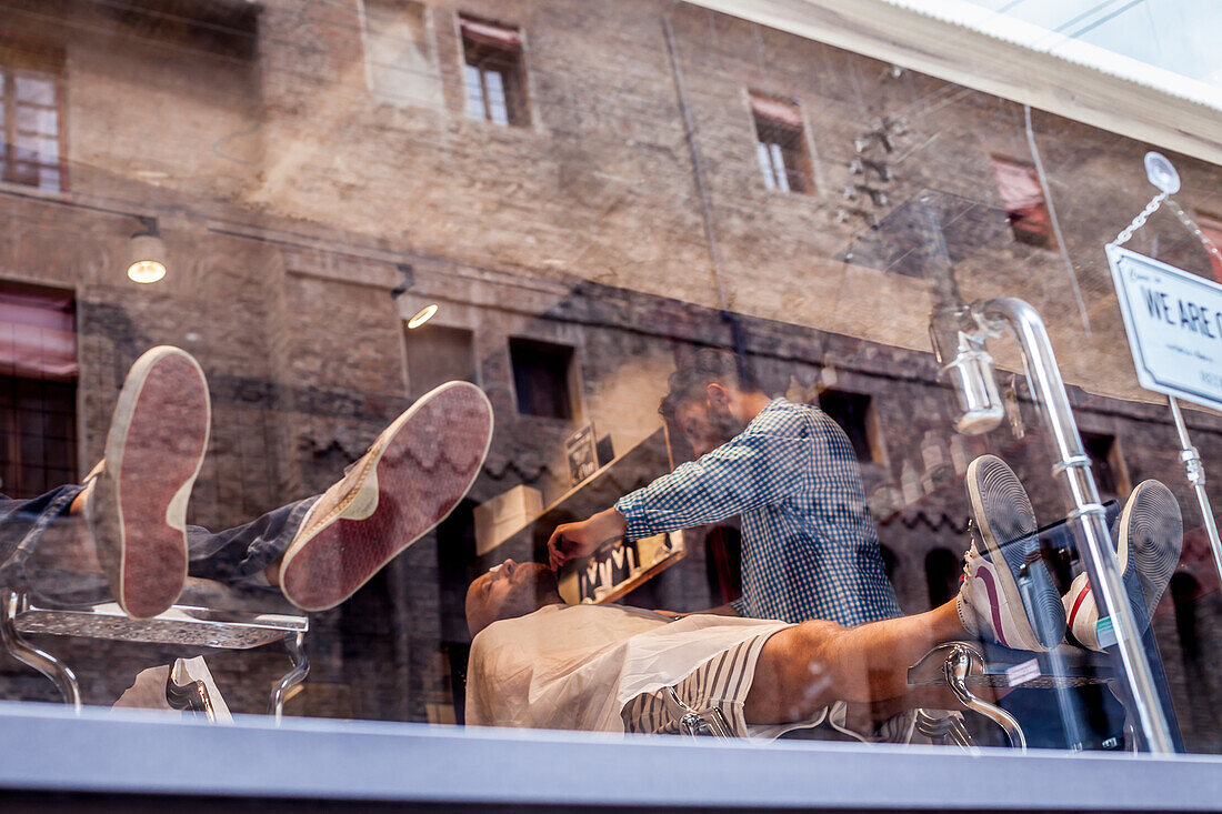 Barber at work, Bologna, Emilia-Romagna, Italy, Europe